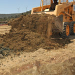 GUANTANAMO BAY, Cuba – Navy Equipment Operator 2nd Class Sammie Gaillard with Naval Mobile Construction Battalion 25, moves dirt to be loaded into a dump truck, March 23, 2010. NMCB 25 is on a six-month deployment in support of Joint Task Force Guantanamo and U.S. Naval Station Guantanamo Bay construction projects. JTF Guantanamo conducts safe, humane, legal and transparent care and custody of detainees, including those convicted by military commission and those ordered released by a court. The JTF conducts intelligence collection, analysis and dissemination for the protection of detainees and personnel working in JTF Guantanamo facilities and in support of the War on Terror. JTF Guantanamo provides support to the Office of Military Commissions, to law enforcement and to war crimes investigations. The JTF conducts planning for and, on order, responds to Caribbean mass migration operations. (JTF Guantanamo photo by Army Spc. Cody Black) UNCLASSIFIED – Cleared for public release. For additional information contact JTF Guantanamo PAO 011-5399-3589; DSN 660-3589 www.jtfgtmo.southcom.mil